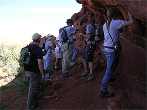Explaining rock formations to a group of students 